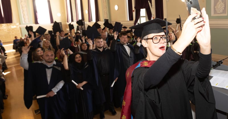 Lisa celebrating graduation with HE students.