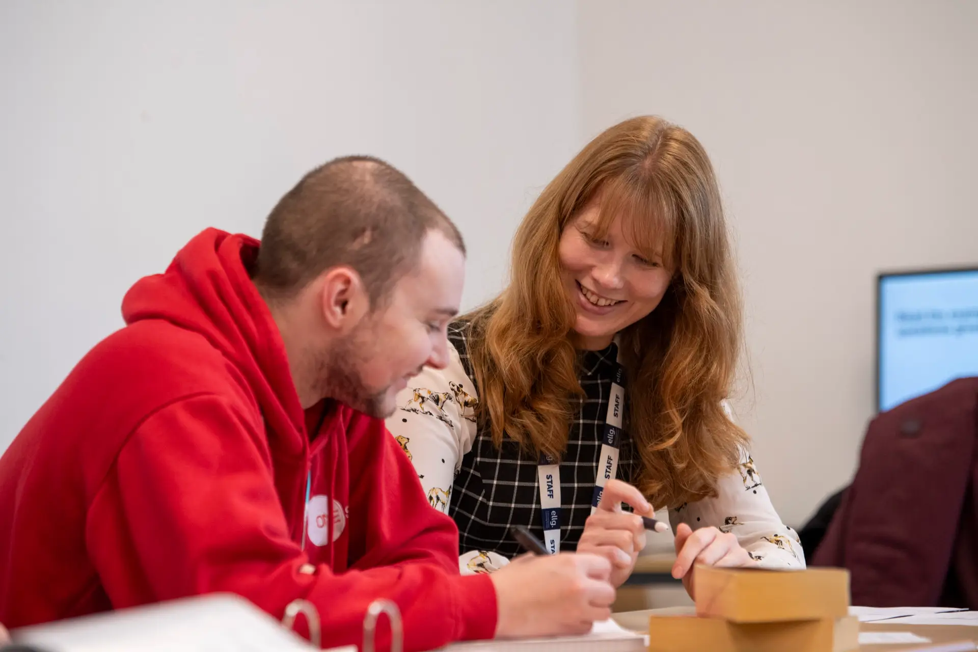 Tutor helping student with work